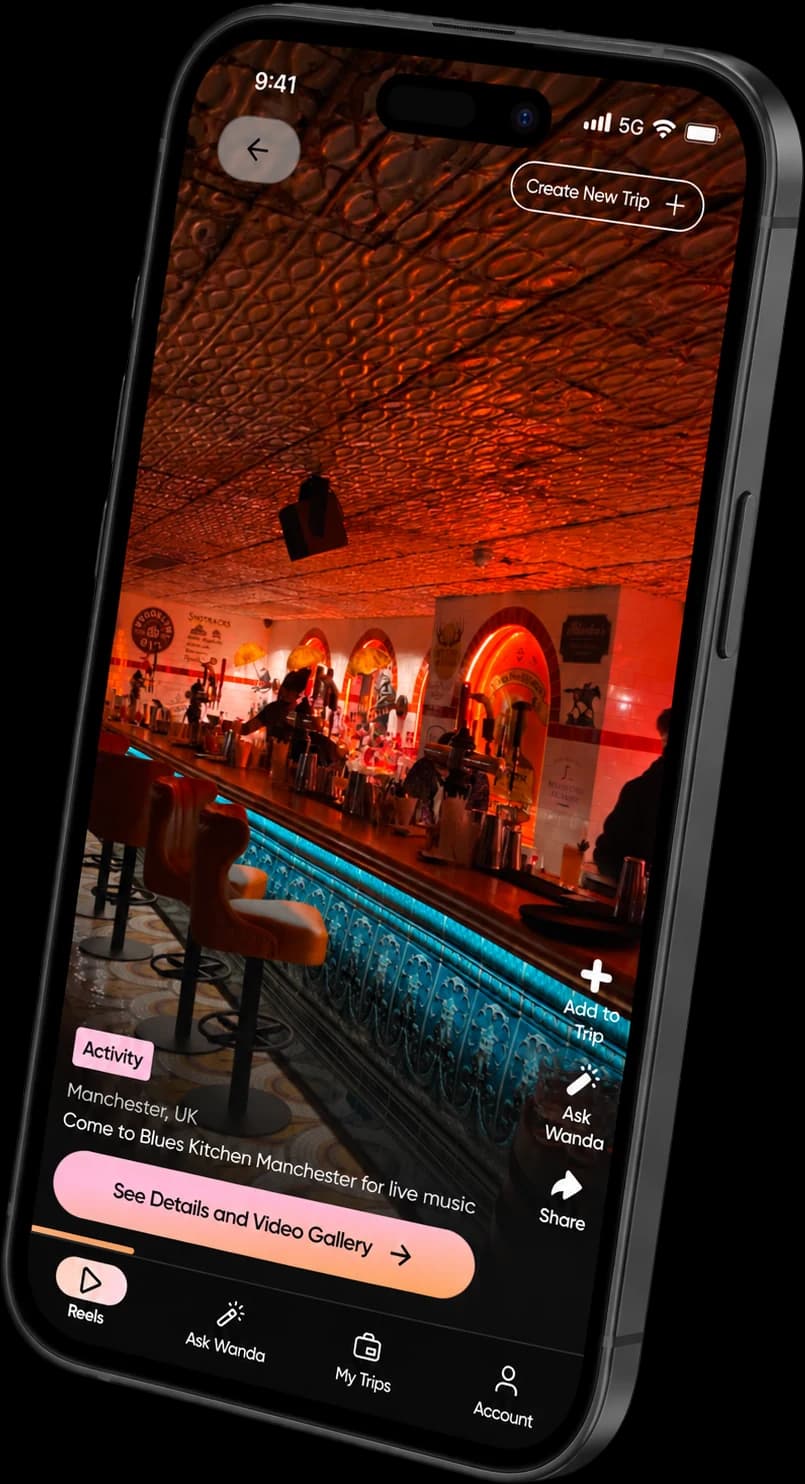 The Super Reel Travel app showing a reel of Blues Kitchen in Manchester, with options to add it to a trip, ask Wanda, and see details