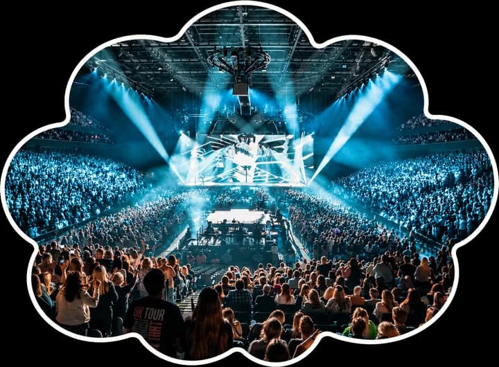 A packed crowd facing the stage at a gig inside Co-op Live